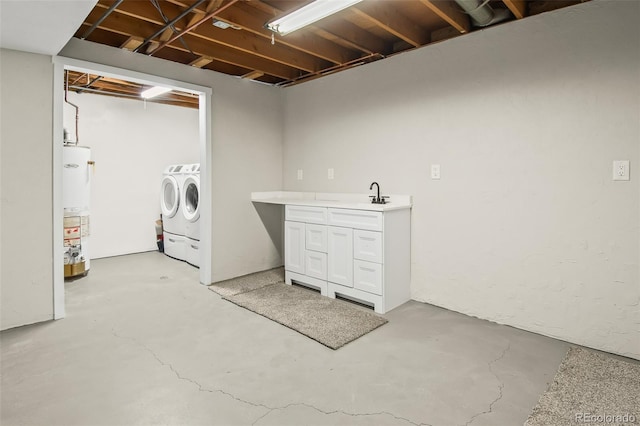 washroom with water heater, sink, and washing machine and clothes dryer