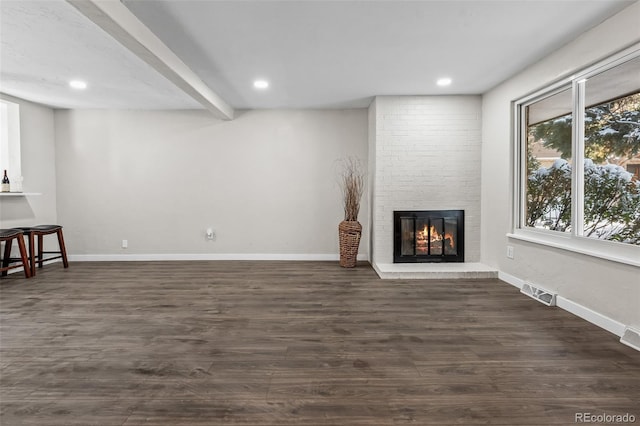 unfurnished living room with dark hardwood / wood-style flooring, a fireplace, and beamed ceiling