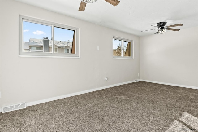 empty room featuring ceiling fan and carpet