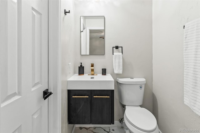 bathroom featuring toilet and vanity