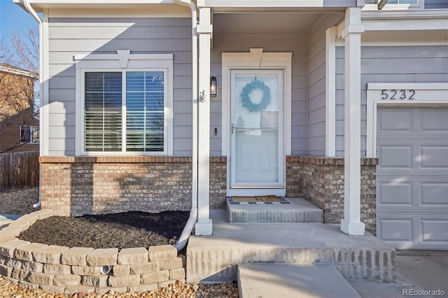 doorway to property with brick siding