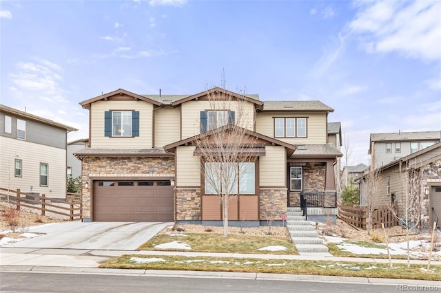 craftsman inspired home with a garage, fence, stone siding, concrete driveway, and roof with shingles