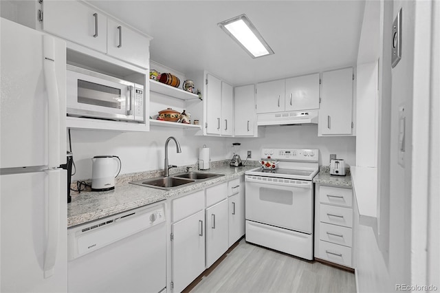 kitchen with sink, white cabinets, light hardwood / wood-style floors, and white appliances