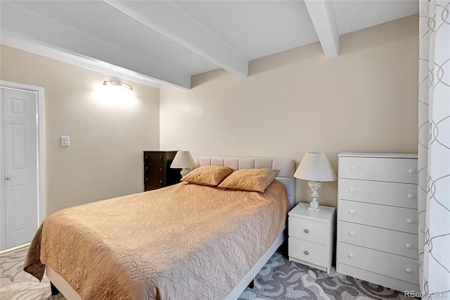 bedroom with carpet flooring and beam ceiling