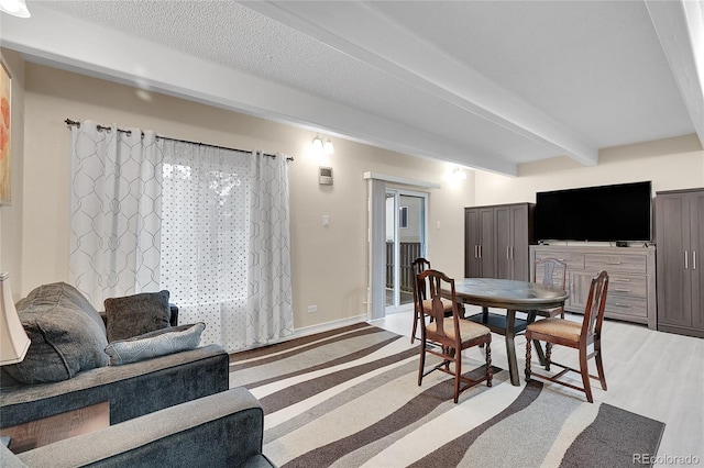 dining space featuring beam ceiling and hardwood / wood-style floors