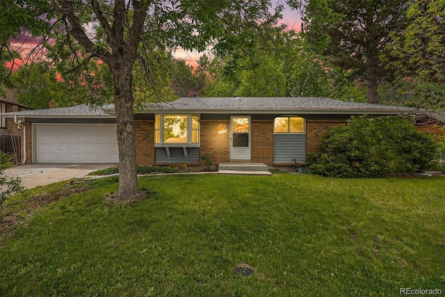 8269 Zephyr St, Arvada, CO 80005 - ranch-style home featuring brick siding, a garage, driveway, and a front yard
