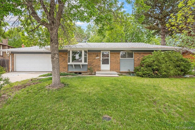 8269 Zephyr St, Arvada, CO 80005 - single story home featuring a garage, brick siding, driveway, and a front yard
