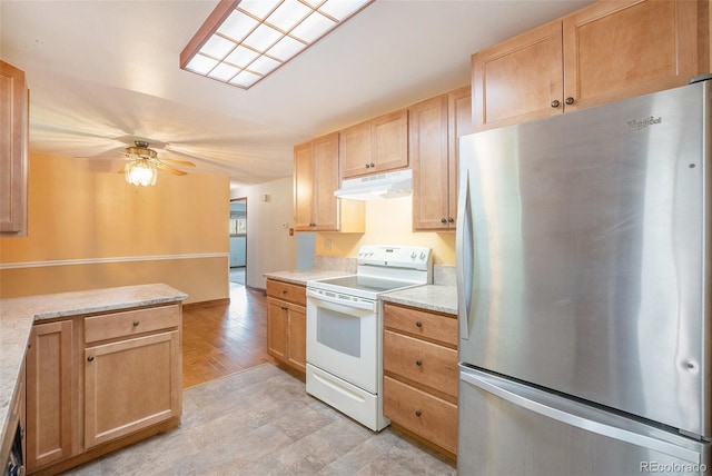 8269 Zephyr St, Arvada, CO 80005 - kitchen with freestanding refrigerator, electric stove, under cabinet range hood, light brown cabinets, and a ceiling fan