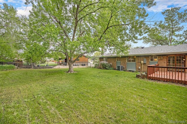 8269 Zephyr St, Arvada, CO 80005 - view of yard featuring central air condition unit and a wooden deck