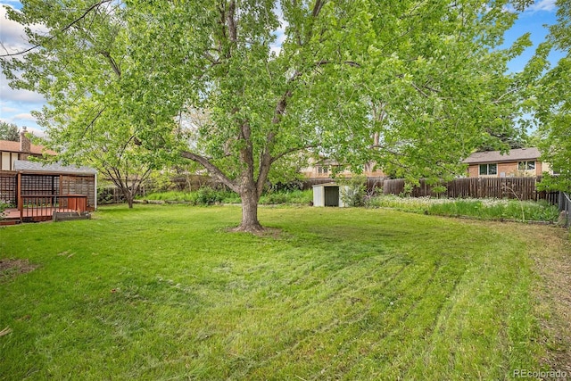 8269 Zephyr St, Arvada, CO 80005 - view of yard with a storage unit, an outbuilding, and a wooden deck