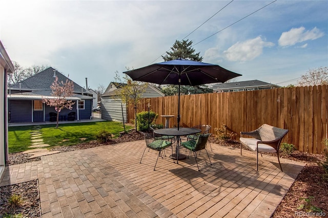 view of patio featuring fence and outdoor dining space