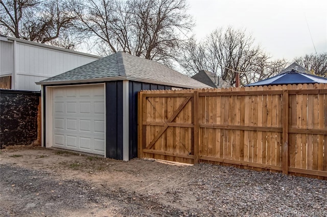 detached garage featuring fence