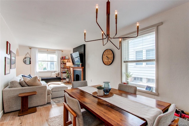 dining area featuring an inviting chandelier and light wood-style floors