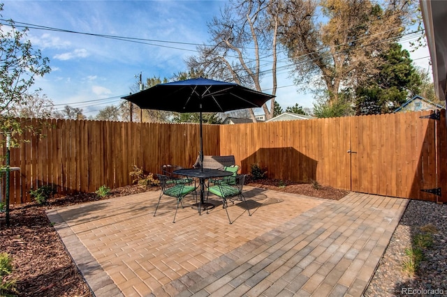 view of patio with a fenced backyard and outdoor dining space