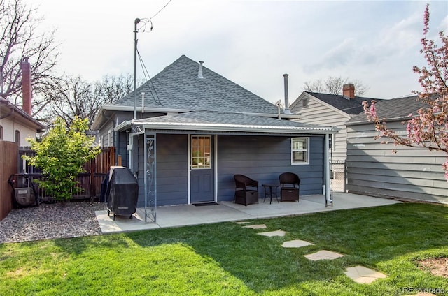 3052 S Cherokee St, Englewood, CO 80110 - rear view of house featuring roof with shingles and a patio