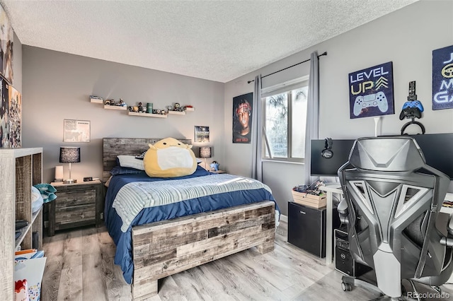 bedroom with hardwood / wood-style floors and a textured ceiling