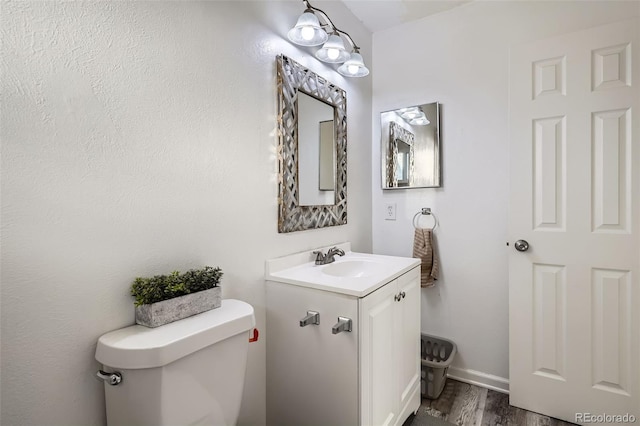 bathroom featuring vanity, toilet, and wood-type flooring