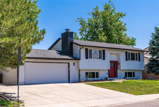 9410 Perry St, Westminster, CO 80031 - split foyer home with an attached garage, driveway, brick siding, and a front yard