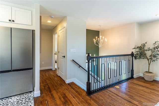 9410 Perry St, Westminster, CO 80031 - hallway with dark wood-style floors, an upstairs landing, and a chandelier