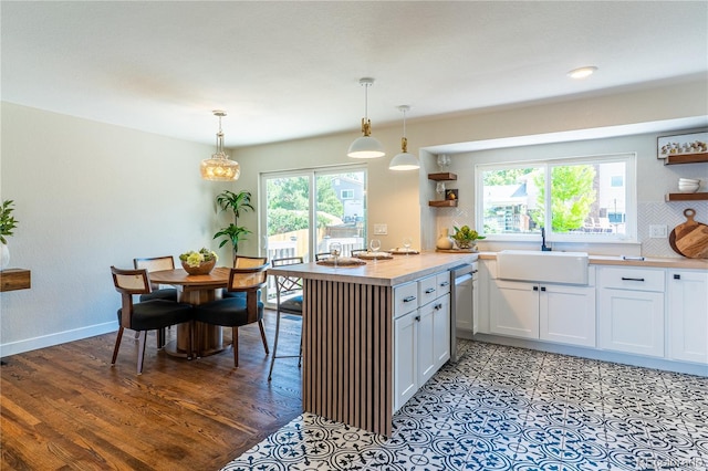 9410 Perry St, Westminster, CO 80031 - kitchen with open shelves, healthy amount of natural light, stainless steel dishwasher, and decorative light fixtures