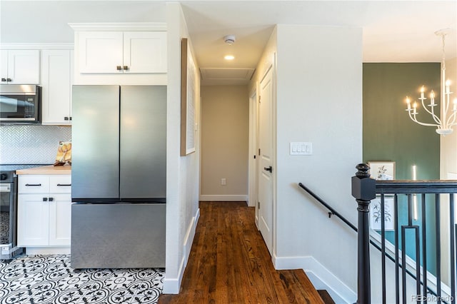 9410 Perry St, Westminster, CO 80031 - kitchen featuring stainless steel appliances, white cabinets, and decorative backsplash