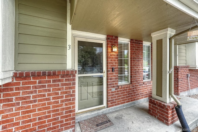 9110 Gale Blvd Unit 3, Thornton, CO 80260 - view of exterior entry with a porch and brick siding