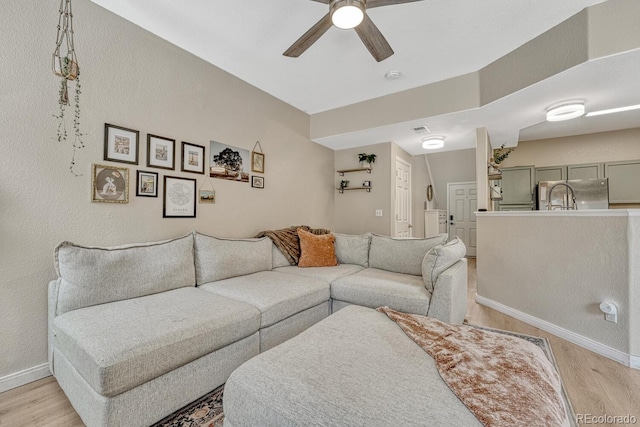 9110 Gale Blvd Unit 3, Thornton, CO 80260 - living area featuring light wood-style flooring, ceiling fan, and baseboards