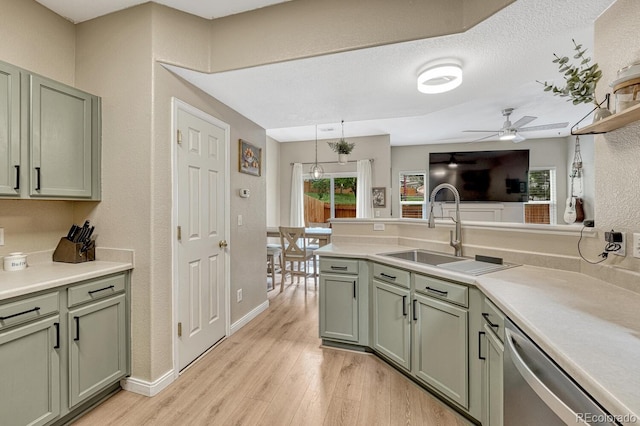 9110 Gale Blvd Unit 3, Thornton, CO 80260 - kitchen with green cabinetry, stainless steel dishwasher, ceiling fan, light wood-style flooring, and a sink