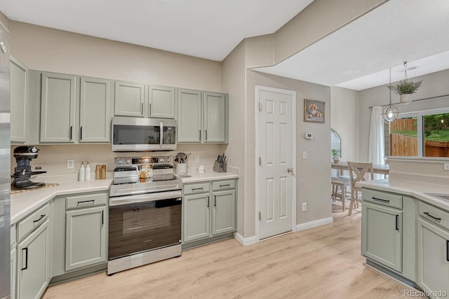 9110 Gale Blvd Unit 3, Thornton, CO 80260 - kitchen with appliances with stainless steel finishes, light wood finished floors, and light countertops