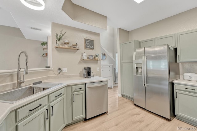 9110 Gale Blvd Unit 3, Thornton, CO 80260 - kitchen with stainless steel appliances, a sink, light wood-type flooring, light countertops, and open shelves