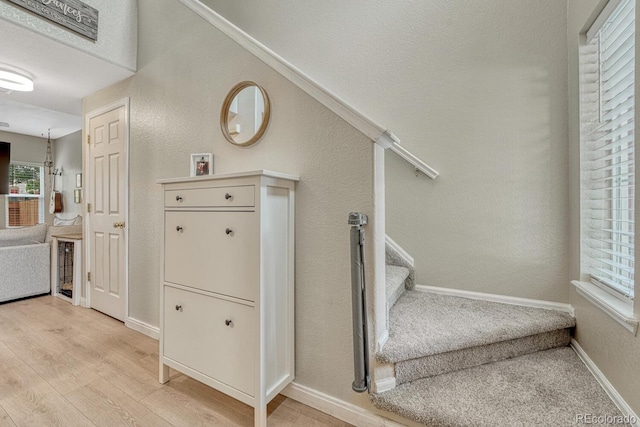 9110 Gale Blvd Unit 3, Thornton, CO 80260 - stairs featuring wood finished floors, healthy amount of natural light, a textured wall, and baseboards
