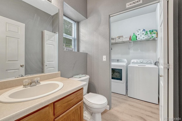 9110 Gale Blvd Unit 3, Thornton, CO 80260 - bathroom featuring washing machine and dryer, a textured wall, wood finished floors, toilet, and vanity