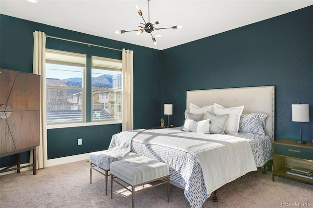 carpeted bedroom featuring a chandelier