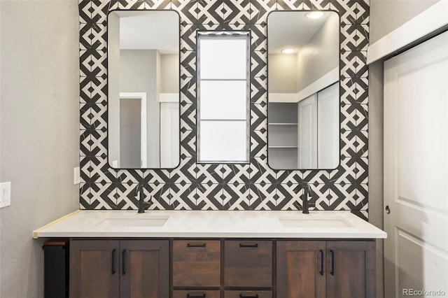 bathroom featuring vanity and decorative backsplash