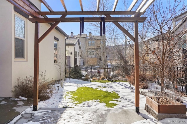 yard covered in snow featuring a pergola