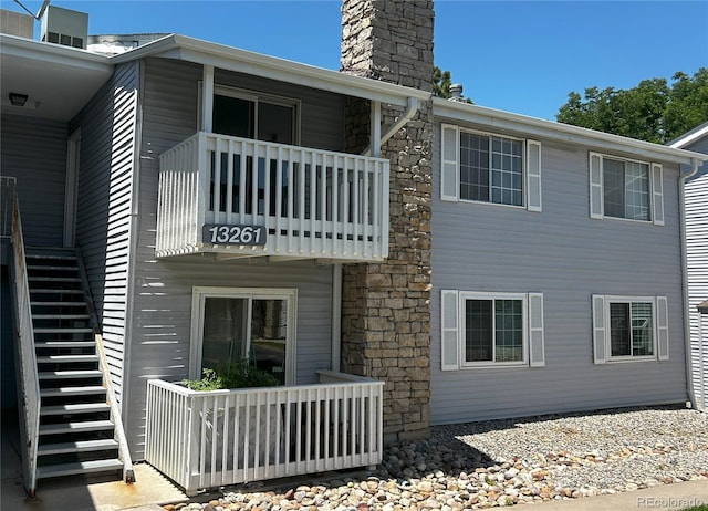 back of property with a balcony