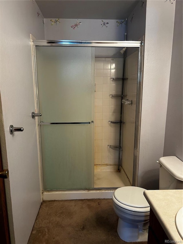 bathroom with vanity, a shower with shower door, and toilet