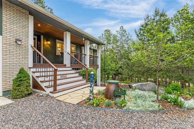 14960 Spiritwood Loop, Elbert, CO 80106 - entrance to property with a porch and brick siding