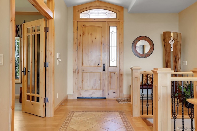 1007 Nob Hill Rd, Evergreen, CO 80439 - entrance foyer with inlaid floor details, baseboards, and wood finished floors