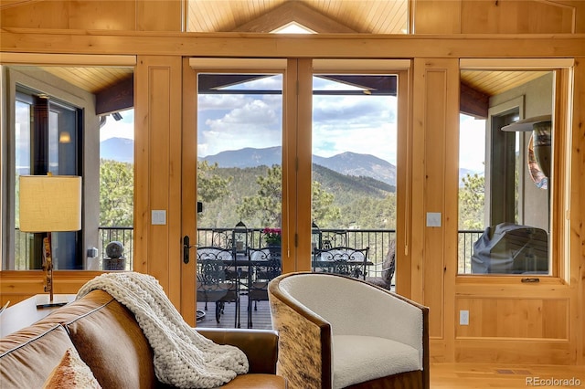 1007 Nob Hill Rd, Evergreen, CO 80439 - sitting room with a mountain view, wood finished floors, wood walls, and vaulted ceiling