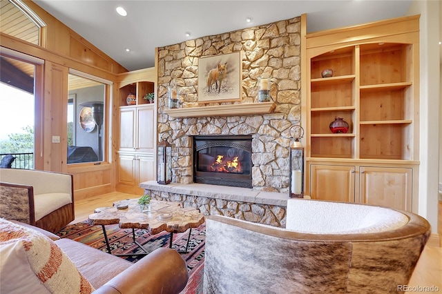 1007 Nob Hill Rd, Evergreen, CO 80439 - living area with a stone fireplace, wood finished floors, recessed lighting, and built in features