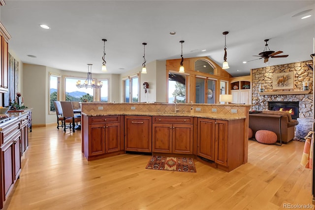 1007 Nob Hill Rd, Evergreen, CO 80439 - kitchen featuring a ceiling fan, light wood-style floors, a sink, a chandelier, and vaulted ceiling