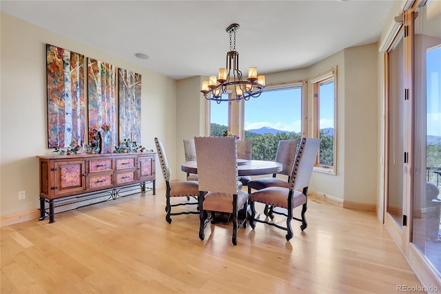 1007 Nob Hill Rd, Evergreen, CO 80439 - dining room with a chandelier, light wood-style floors, baseboards, and a mountain view