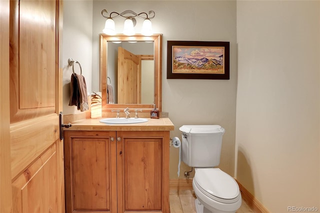 1007 Nob Hill Rd, Evergreen, CO 80439 - bathroom featuring toilet, vanity, and baseboards