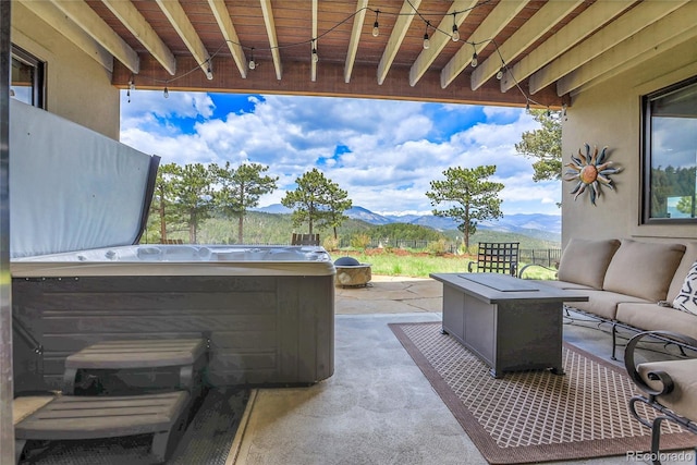 1007 Nob Hill Rd, Evergreen, CO 80439 - view of patio featuring a mountain view, an outdoor living space, and a hot tub