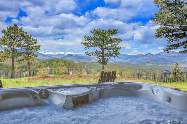 1007 Nob Hill Rd, Evergreen, CO 80439 - view of patio with a hot tub and a mountain view