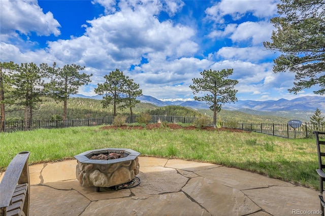 1007 Nob Hill Rd, Evergreen, CO 80439 - fenced backyard with a mountain view, a fire pit, and a patio