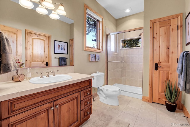 1007 Nob Hill Rd, Evergreen, CO 80439 - bathroom featuring a stall shower, vanity, toilet, and tile patterned flooring