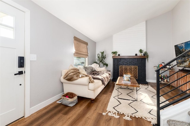 4800 S Tabor St, Morrison, CO 80465 - living room with plenty of natural light, vaulted ceiling, wood finished floors, and a fireplace