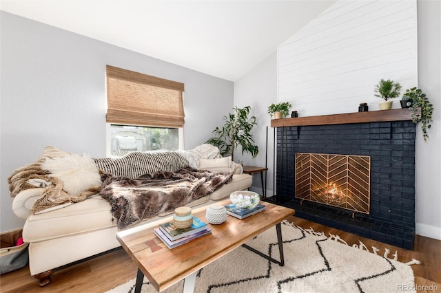 4800 S Tabor St, Morrison, CO 80465 - living room featuring a brick fireplace, lofted ceiling, and wood finished floors